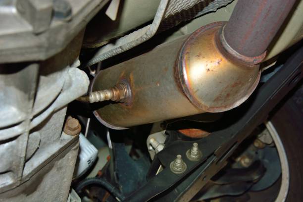 A catalytic converter is visible underneath a car.